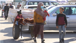 With Four Kids By Her Side, A Tajik Mother Collects Trash To Make Meager Living