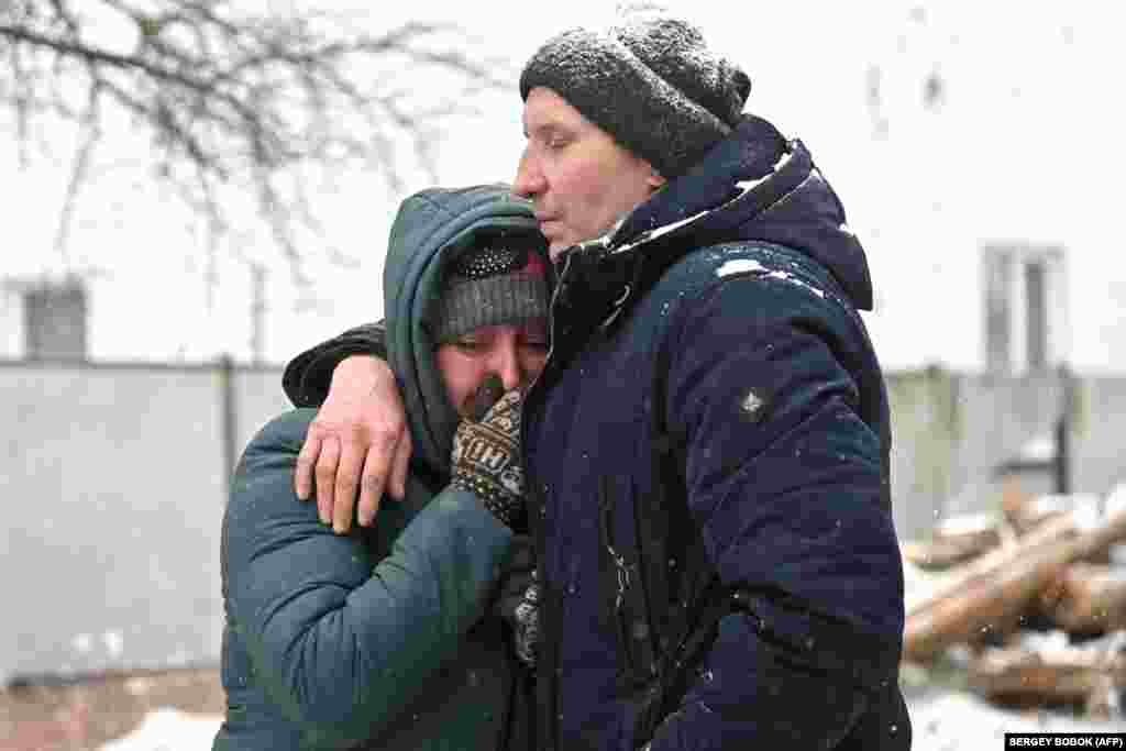 Residents react to the destruction following the missile attack in Zmiyiv. Two people were killed in the Khmelnitskiy region, where at least six explosions that also caused damage to infrastructure facilities were reported on Telegram by the region's state administration. 