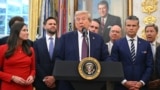 US President Donald Trump, surrounded by senior officials, speaks at the White House on September 2