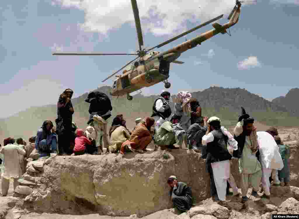 A Taliban helicopter takes off after bringing aid to Gayan. The United Nations said it was deploying medical health teams and supplying medicines, but it said it does not have search-and-rescue capabilities in Afghanistan. 