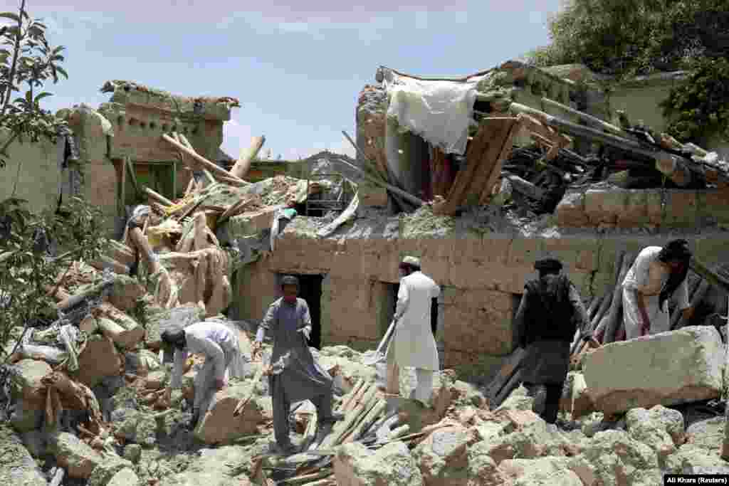 Afghan men search for survivors amid the rubble of a house destroyed by the earthquake, on June 23 in Paktika Province's Gayan district. The Taliban declared the search for survivors to be over on June 24. The disaster poses a challenge for the Taliban-led government, which is largely isolated as a result of its hard-line Islamist policies toward women and girls. The country had already been battling a severe humanitarian crisis after crucial foreign aid was halted following the Taliban takeover in August 2021. 