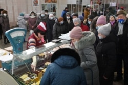 Покупатели выстраиваются в очередь у прилавка на рынке в Омске. Россия, 18 февраля 2022 года.