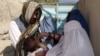 A health worker administers the polio vaccine to a child in Kandahar. (file photo)