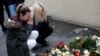 Women mourn at the scene where a truck ploughed into a crowded Christmas market in the German capital Berlin on December 19.