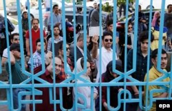 Iranians wait in line to cast their ballots at a polling station in Iran on May 19.