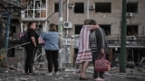 Residents observe the damage to an apartment building in Zaporizhzhya after a Russian air attack on August 30.