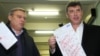 Opposition leaders Mikhail Kasyanov (left) and Boris Nemtsov show their defaced ballots during parliamentary elections at a polling station in Moscow in December 2011.