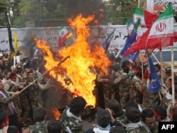 Basij members burn a U.S. flag during a protest outside the former American embassy in Tehran. (file photo)
