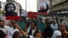 Pakistani human rights activists hold images of missing activist Salman Haider during a protest in Karachi on January 9.