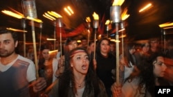 People carry torches to mark the 97th anniversary of the genocide of their kin by Ottoman Turks during World War I in central Yerevan on April 23.