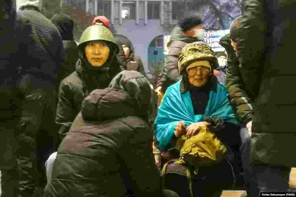 Protesters wearing military-style helmets in Almaty on January 5. 