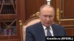 Президент России Владимир Путин перед книжным шкафом в своем кабинете в Сенатском дворце Кремля в Москве